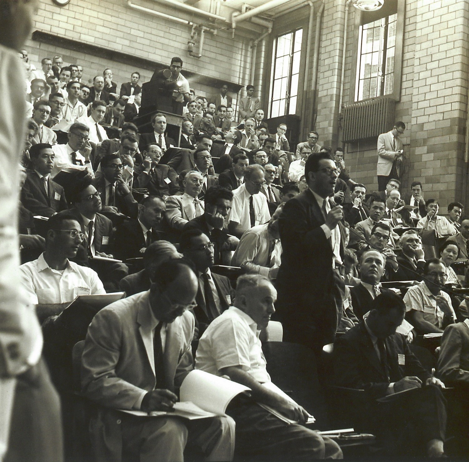 The photo of Feza Gürsey taken in a large group of audience members in 1960 at University of Rochester during the Tenth Annual Conference on High Energy Physics