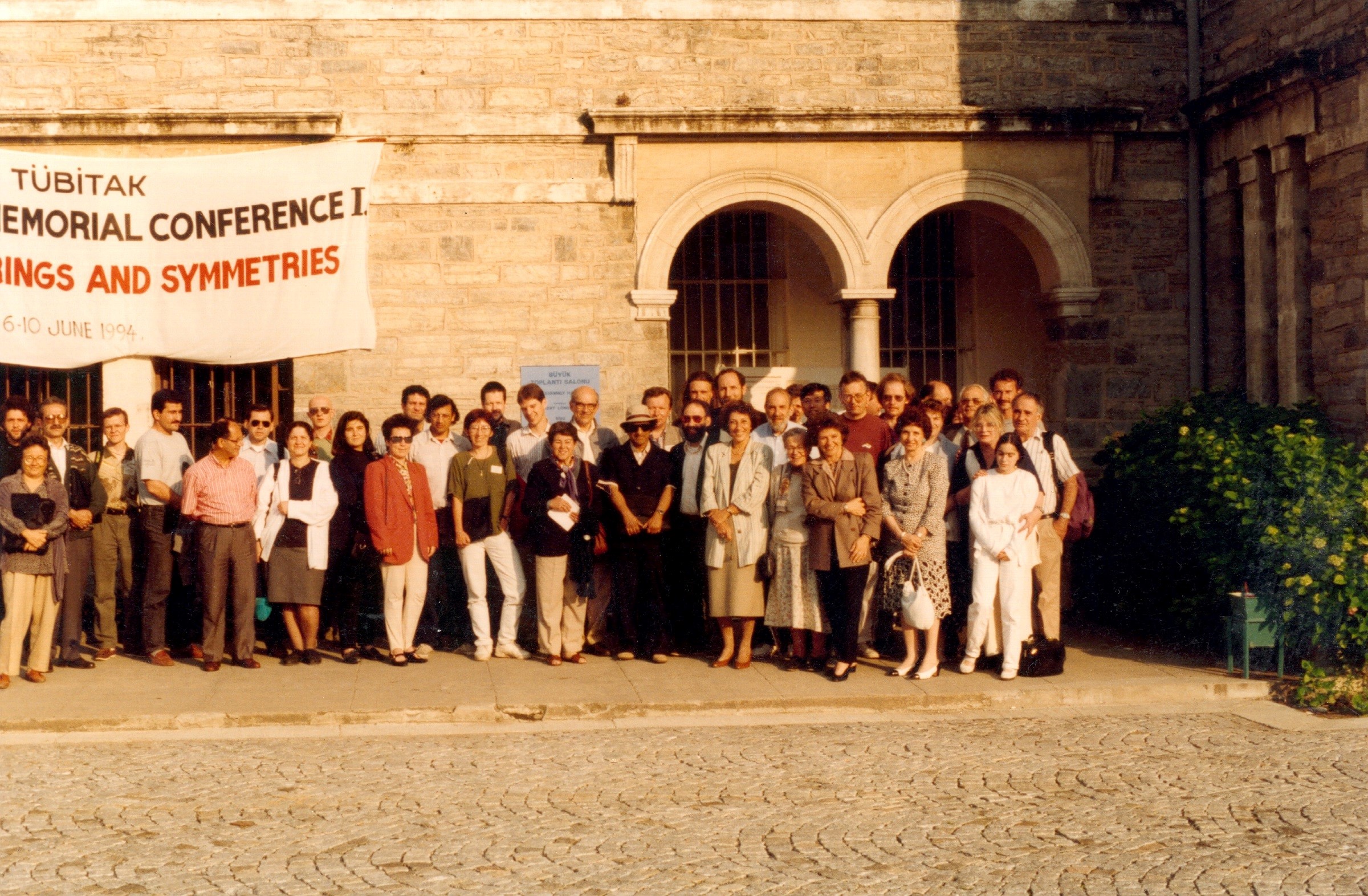 Participants of the Strings and Symmetries conference held in memory of Feza Gürsey at Boğaziçi University, Suha Gürsey and Deha Owen together, 1994